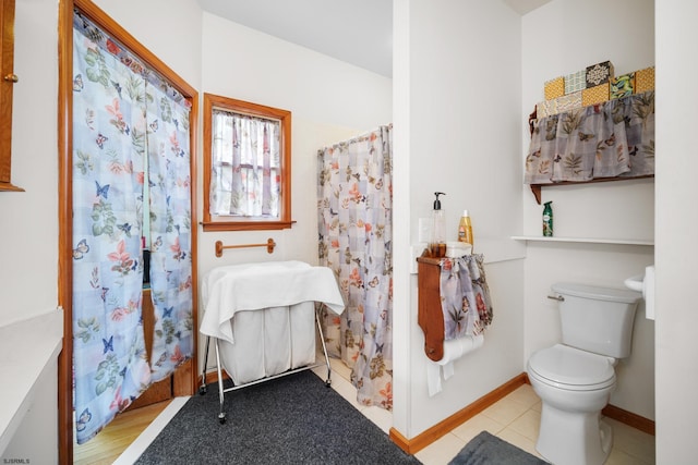 bathroom with tile patterned flooring and toilet