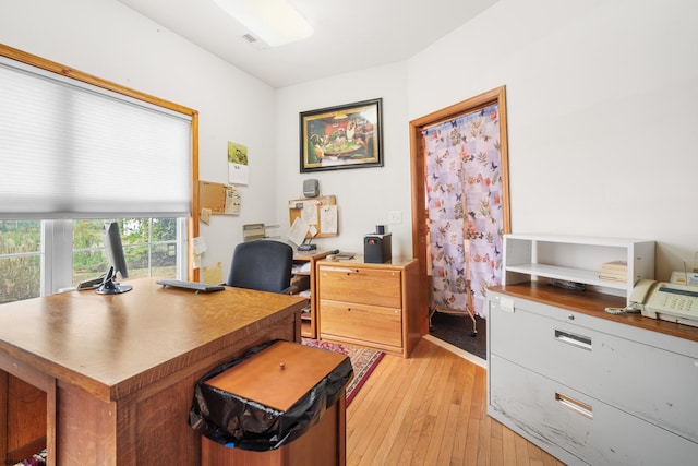 office with light hardwood / wood-style floors