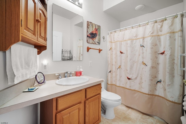 bathroom with curtained shower, tile patterned flooring, vanity, and toilet