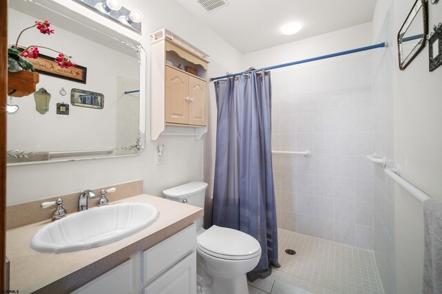 bathroom with walk in shower, vanity, tile patterned flooring, and toilet