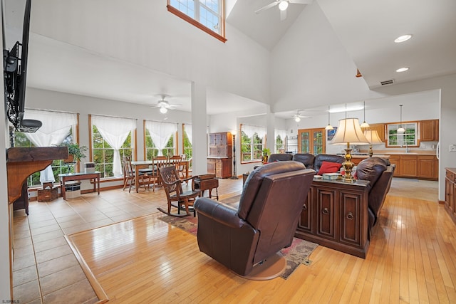 living room with ceiling fan and plenty of natural light