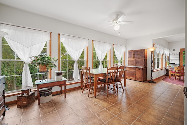 tiled dining space with ceiling fan