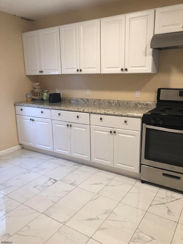 kitchen featuring white cabinetry and stainless steel range oven