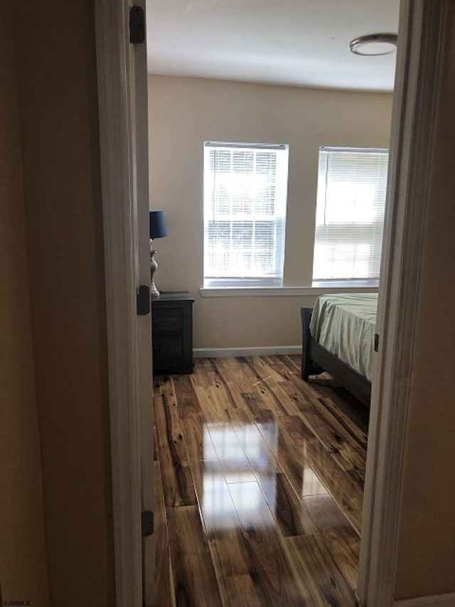bedroom featuring baseboards and wood finished floors