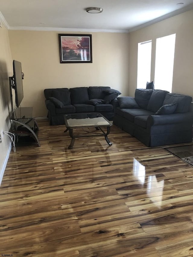 living room with baseboards, ornamental molding, and dark wood-type flooring
