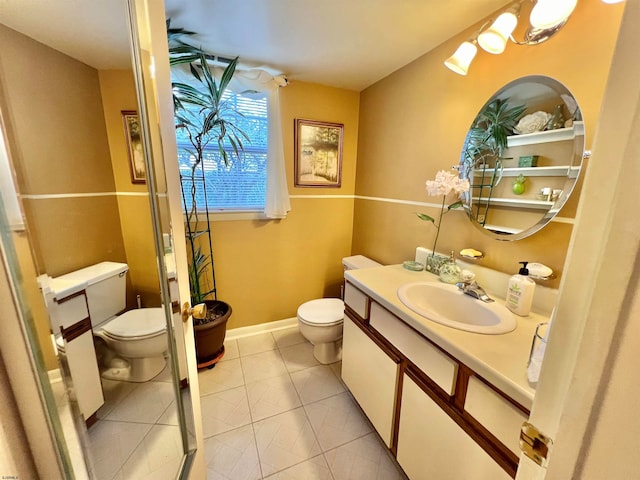 bathroom with tile patterned flooring, vanity, and toilet