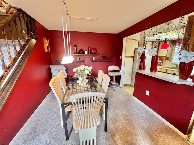 dining room featuring carpet floors and sink