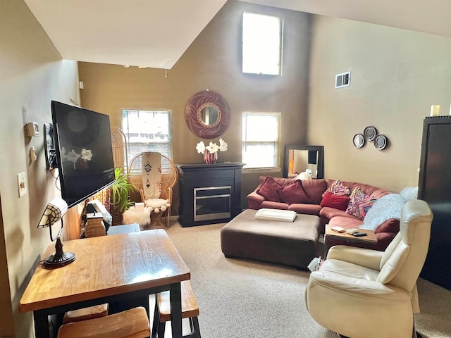 living room with carpet flooring and high vaulted ceiling