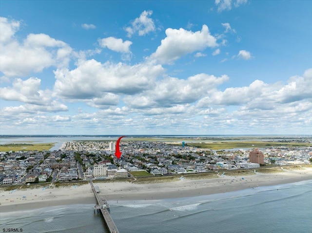 birds eye view of property featuring a water view and a view of the beach