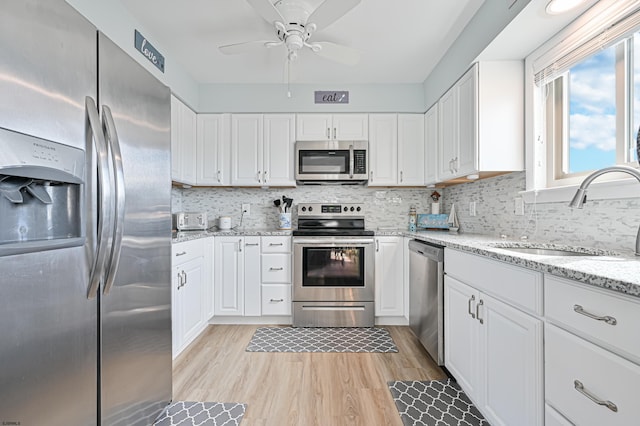 kitchen with white cabinets, appliances with stainless steel finishes, and sink