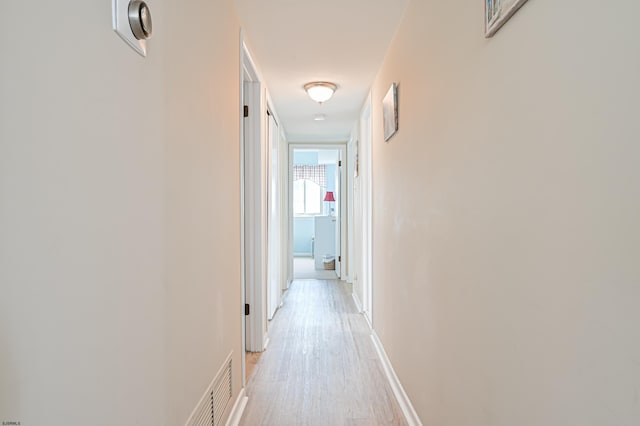 hallway with light wood-type flooring