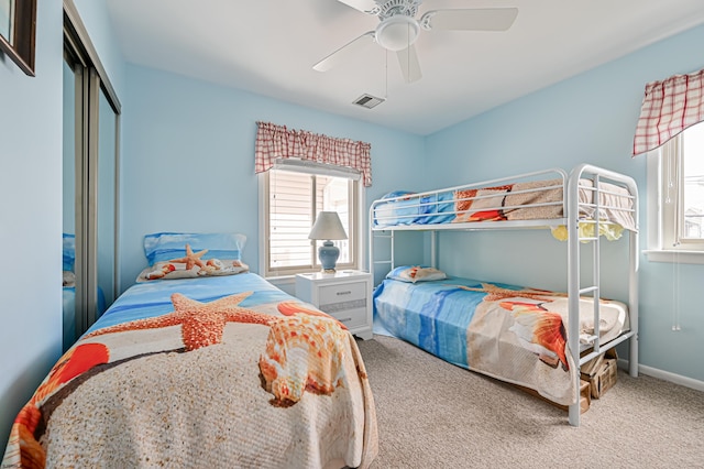 carpeted bedroom with a closet and ceiling fan