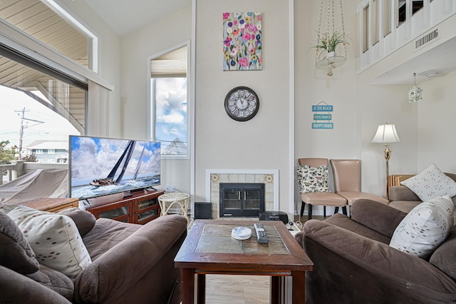 living room featuring a tile fireplace