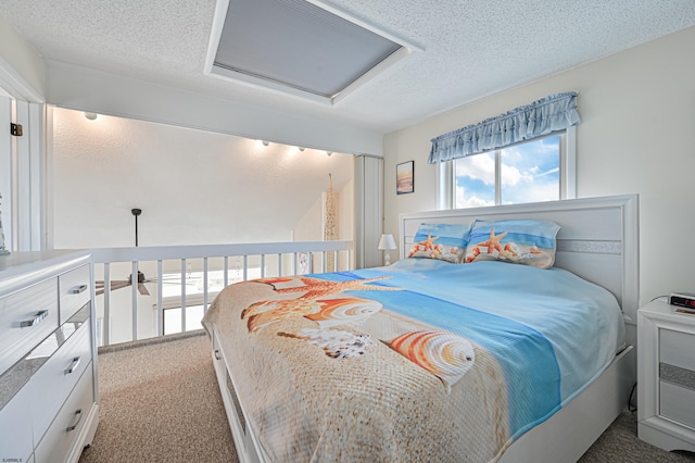 carpeted bedroom featuring a textured ceiling