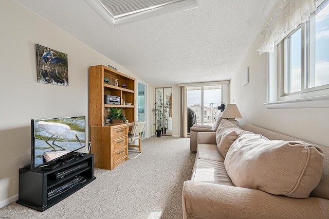 living room with a textured ceiling, vaulted ceiling, and carpet