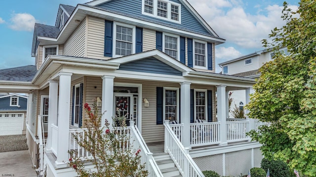 view of front facade featuring a porch and a garage