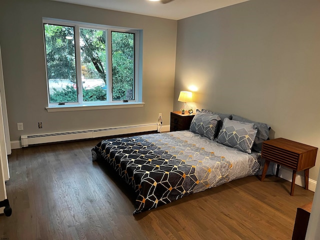 bedroom featuring a baseboard radiator and hardwood / wood-style flooring