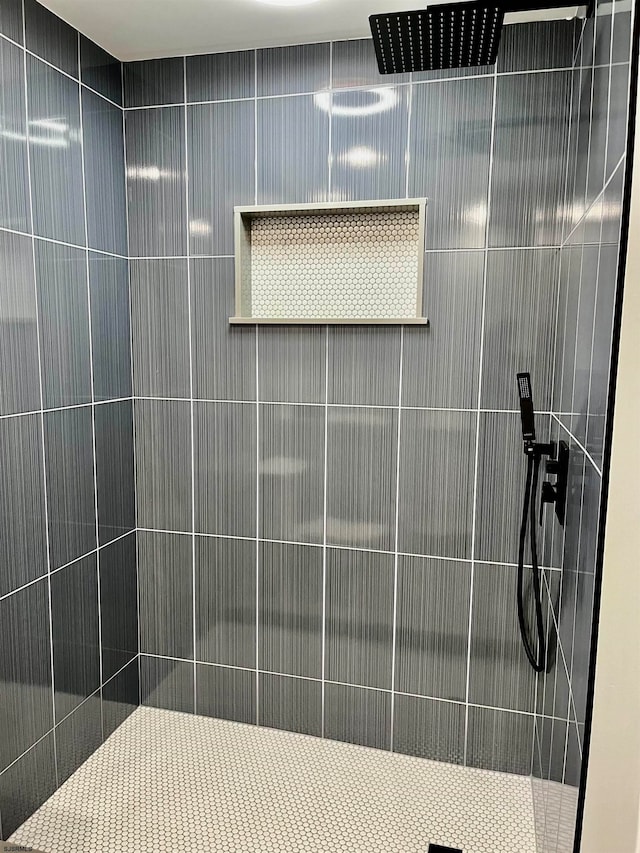 bathroom with a tile shower