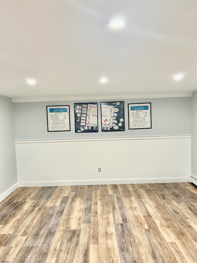 basement with hardwood / wood-style floors