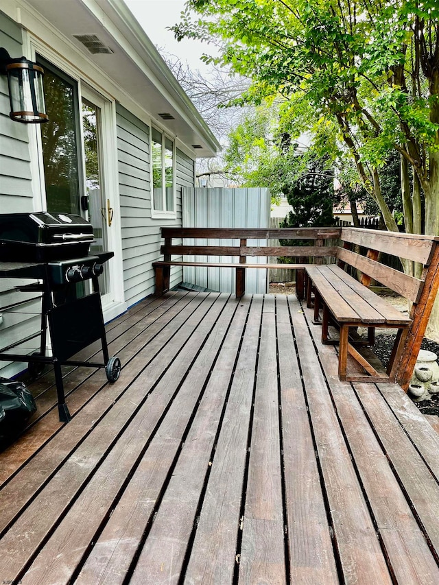 wooden deck featuring a grill