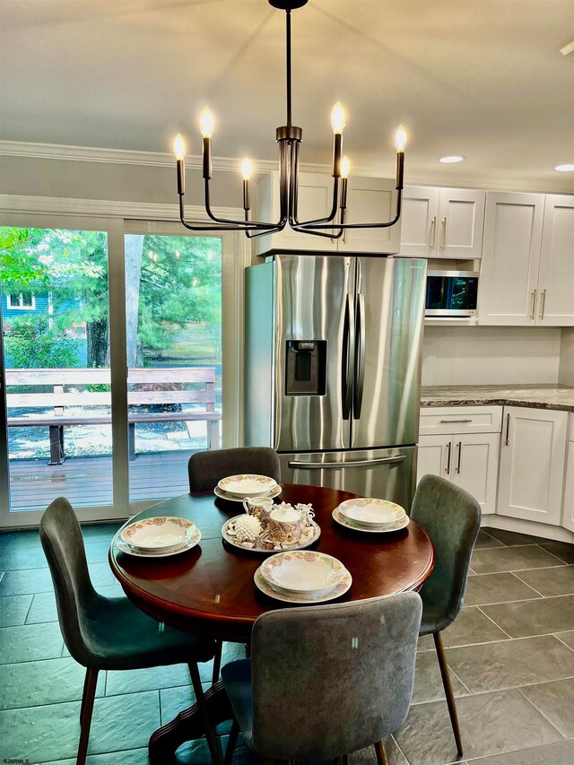 dining space featuring a notable chandelier and ornamental molding