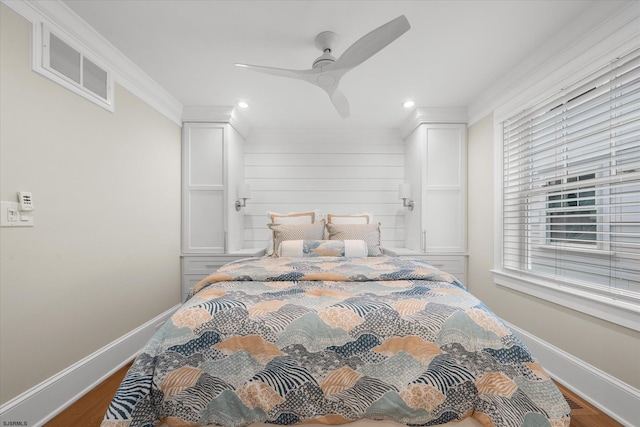 bedroom featuring ceiling fan, hardwood / wood-style flooring, and crown molding