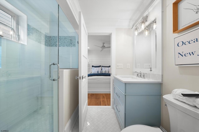 bathroom with vanity, walk in shower, crown molding, ceiling fan, and toilet