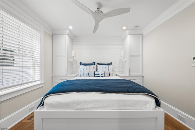 bedroom featuring ceiling fan, ornamental molding, and dark hardwood / wood-style flooring