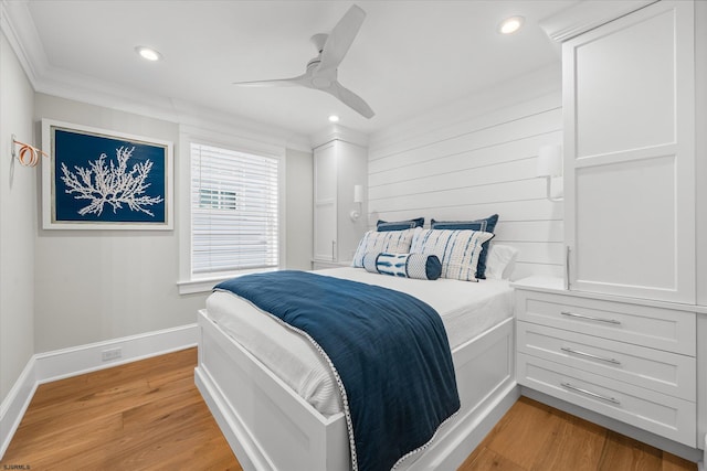 bedroom featuring crown molding, ceiling fan, and light hardwood / wood-style flooring