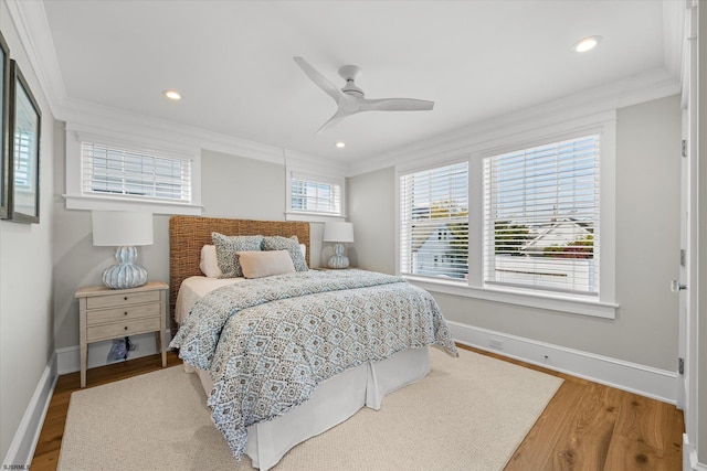 bedroom with ornamental molding, hardwood / wood-style floors, and ceiling fan