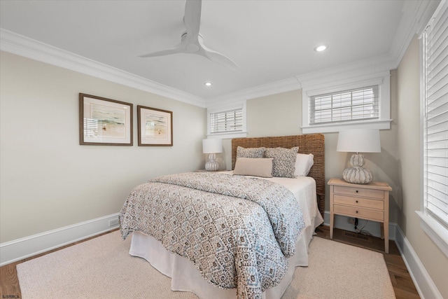 bedroom featuring multiple windows, crown molding, ceiling fan, and hardwood / wood-style flooring