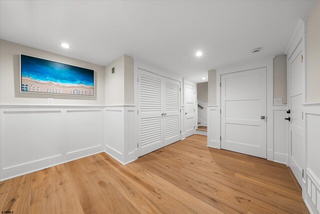 hallway with light hardwood / wood-style flooring