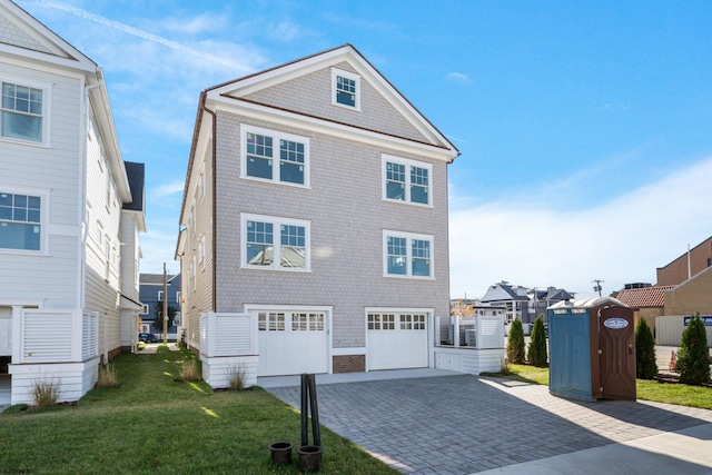 view of front of home with a garage and a front lawn