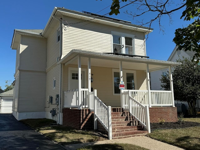 view of front of home with a garage and a porch