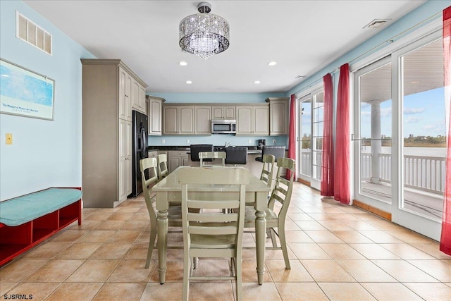 dining space featuring an inviting chandelier and light tile patterned flooring