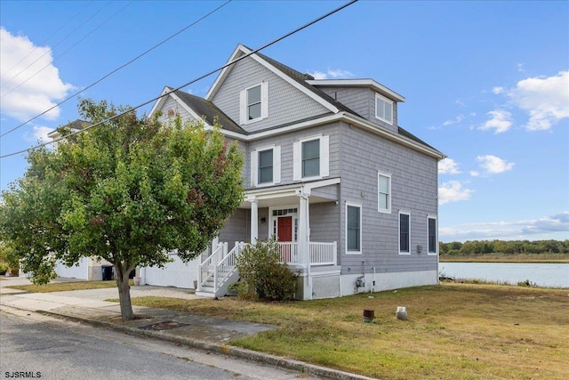 view of front facade with a front lawn and covered porch