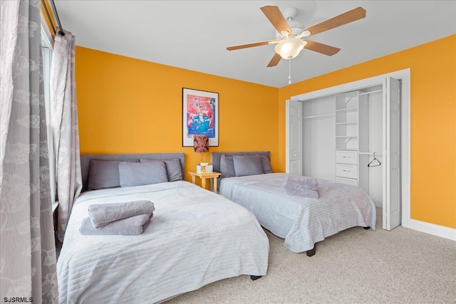 bedroom with carpet floors, ceiling fan, and a closet