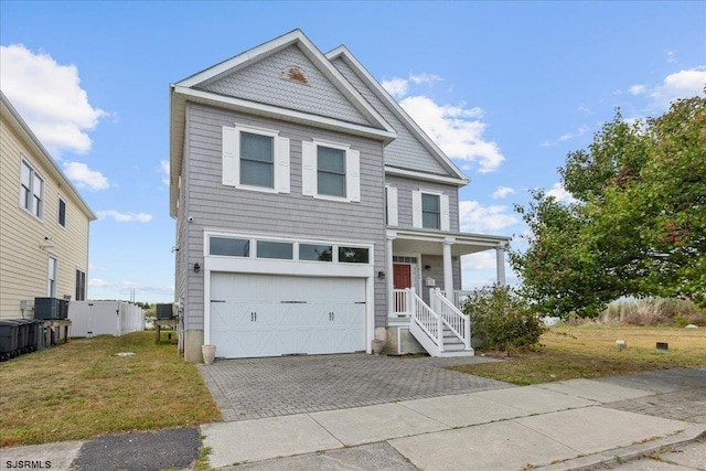 view of front of house featuring a front yard, a garage, covered porch, and central air condition unit