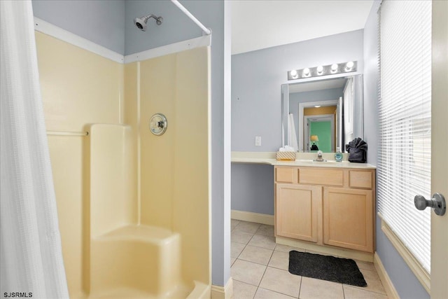 bathroom with a shower with shower curtain, tile patterned flooring, and vanity