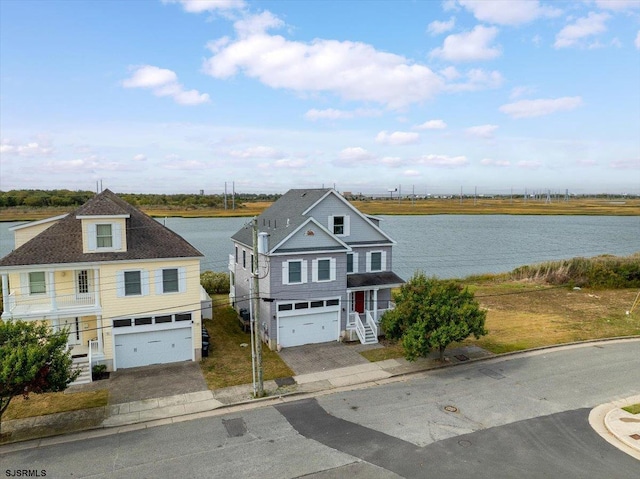 exterior space with a water view, a porch, and a garage