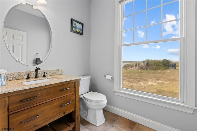 bathroom featuring tile patterned flooring, vanity, and toilet