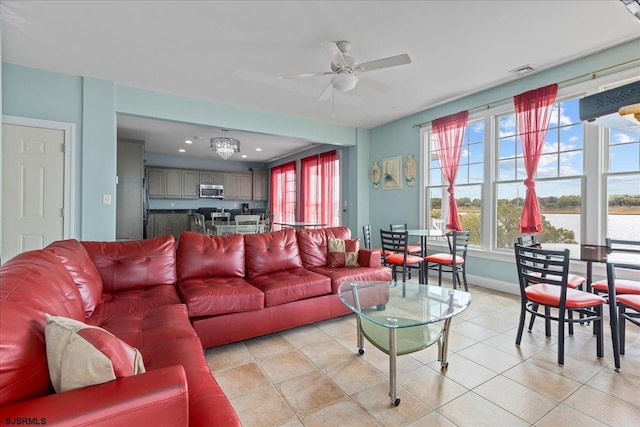 living room featuring a wealth of natural light, ceiling fan, and light tile patterned flooring