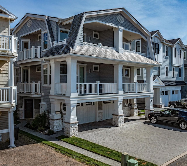 view of front of home featuring a balcony and a garage