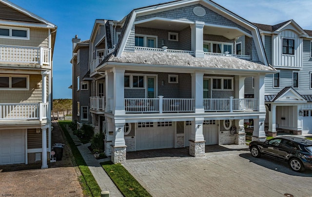 townhome / multi-family property featuring a balcony and a garage