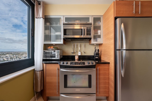 kitchen featuring stainless steel appliances and tasteful backsplash