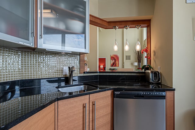 kitchen with light brown cabinetry, decorative backsplash, stainless steel dishwasher, and sink