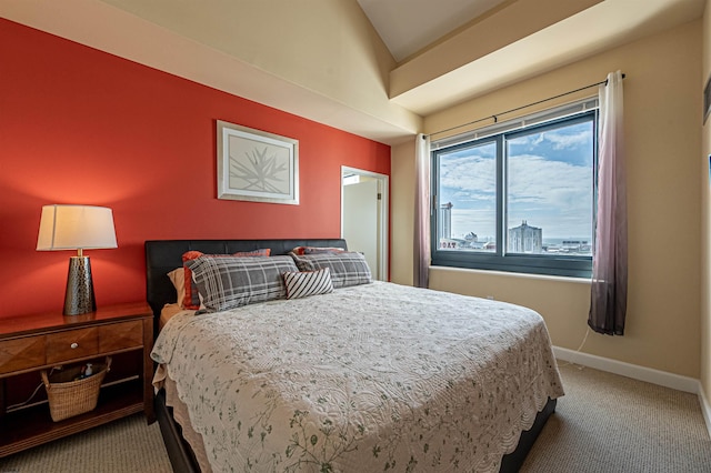 bedroom featuring lofted ceiling and carpet flooring