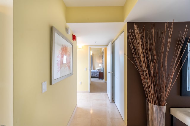 hall featuring light tile patterned floors