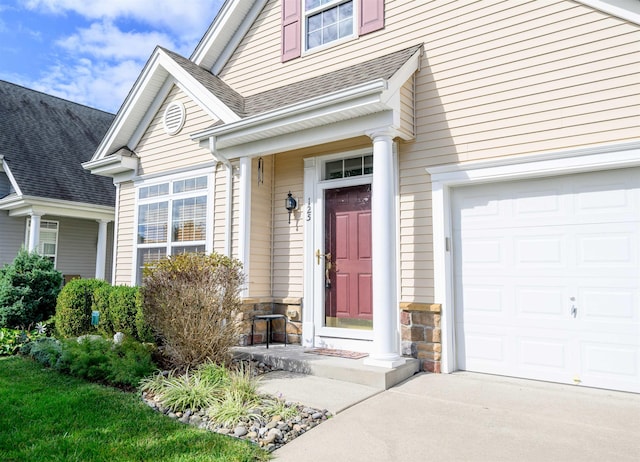 doorway to property with a garage