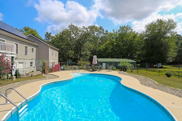 view of pool featuring a lawn and a patio area